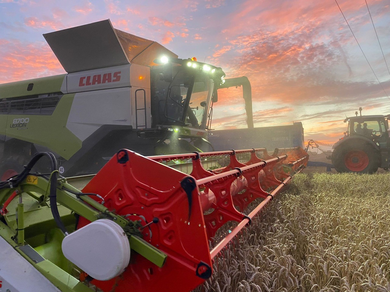 Combine harvester during sunset